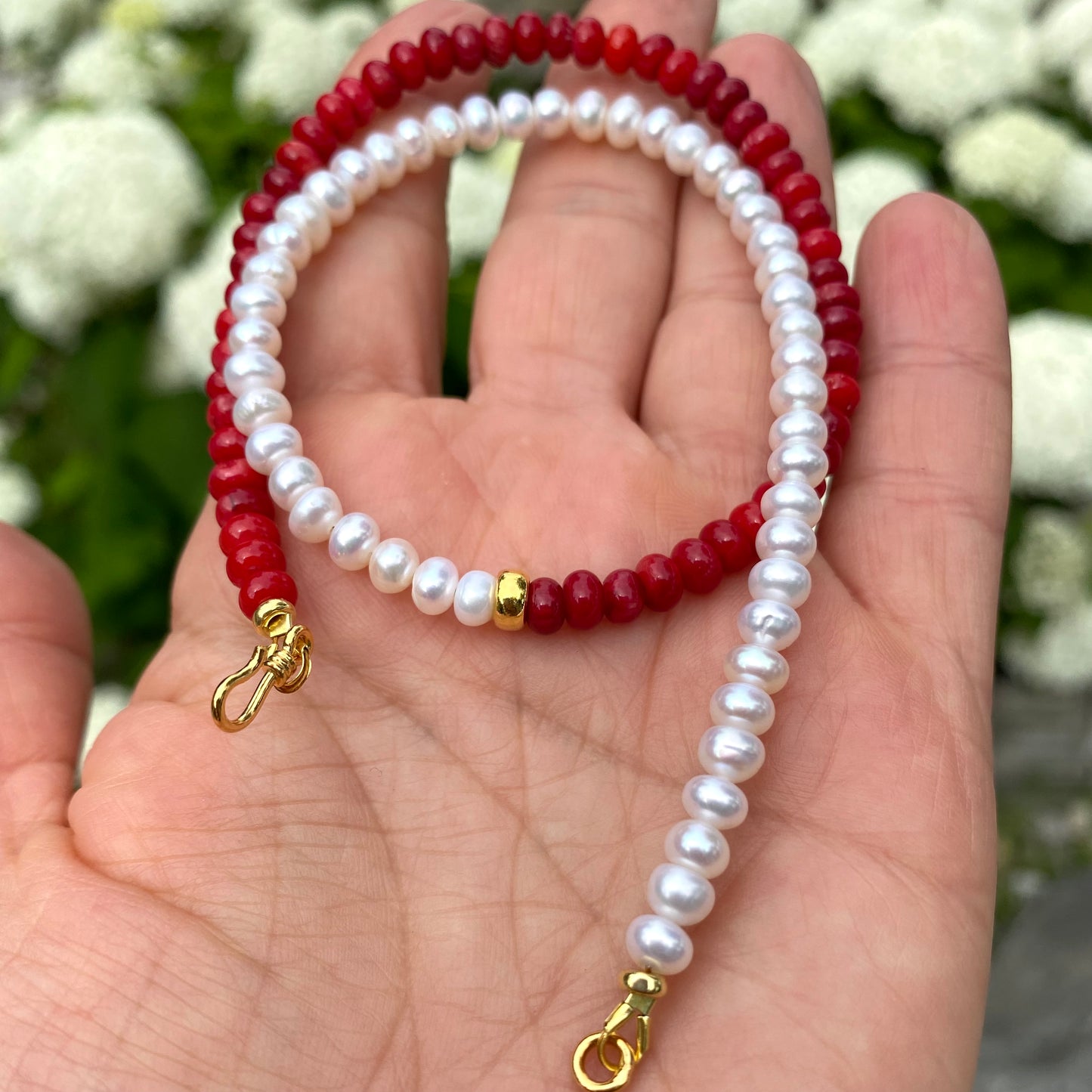Half Coral Half Pearl Choker Necklace in hand showing gold vermeil S-clasp and half coral half pearl design