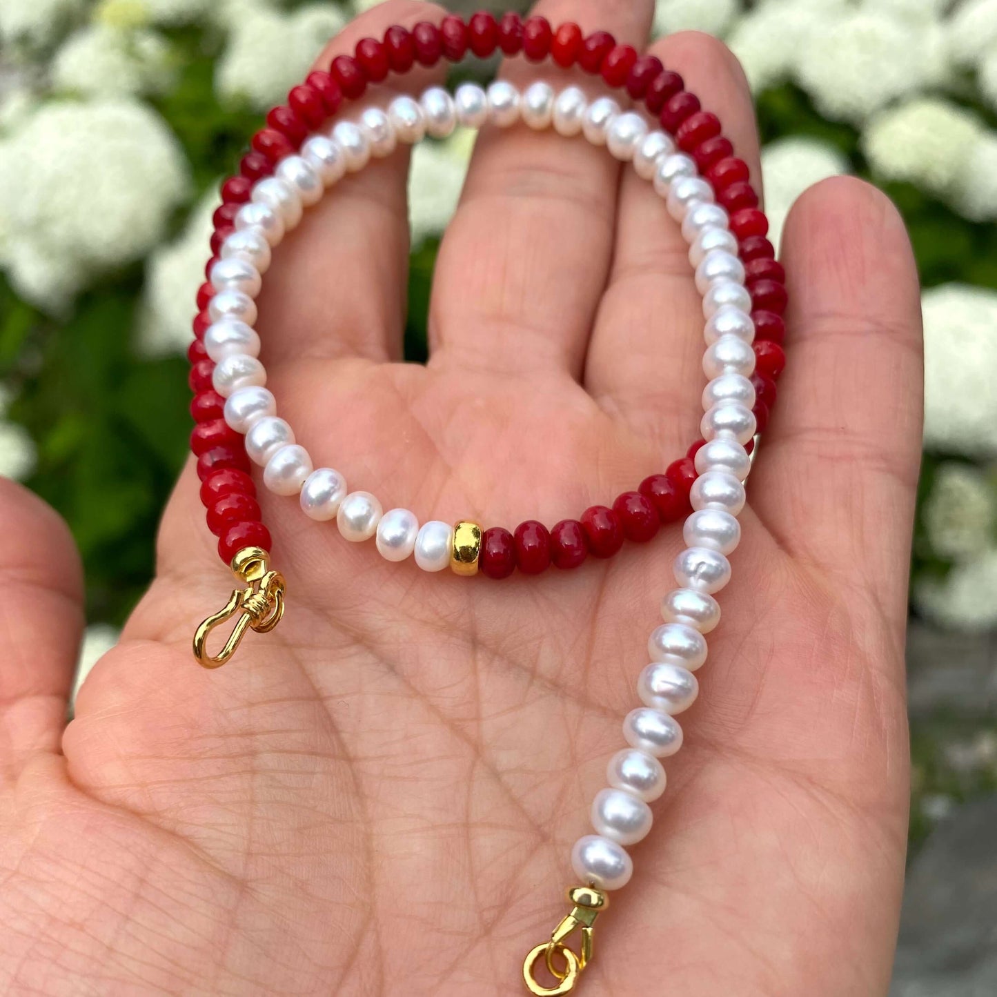 Half Coral Half Pearl Choker Necklace in hand showing gold vermeil S-clasp and half coral half pearl design