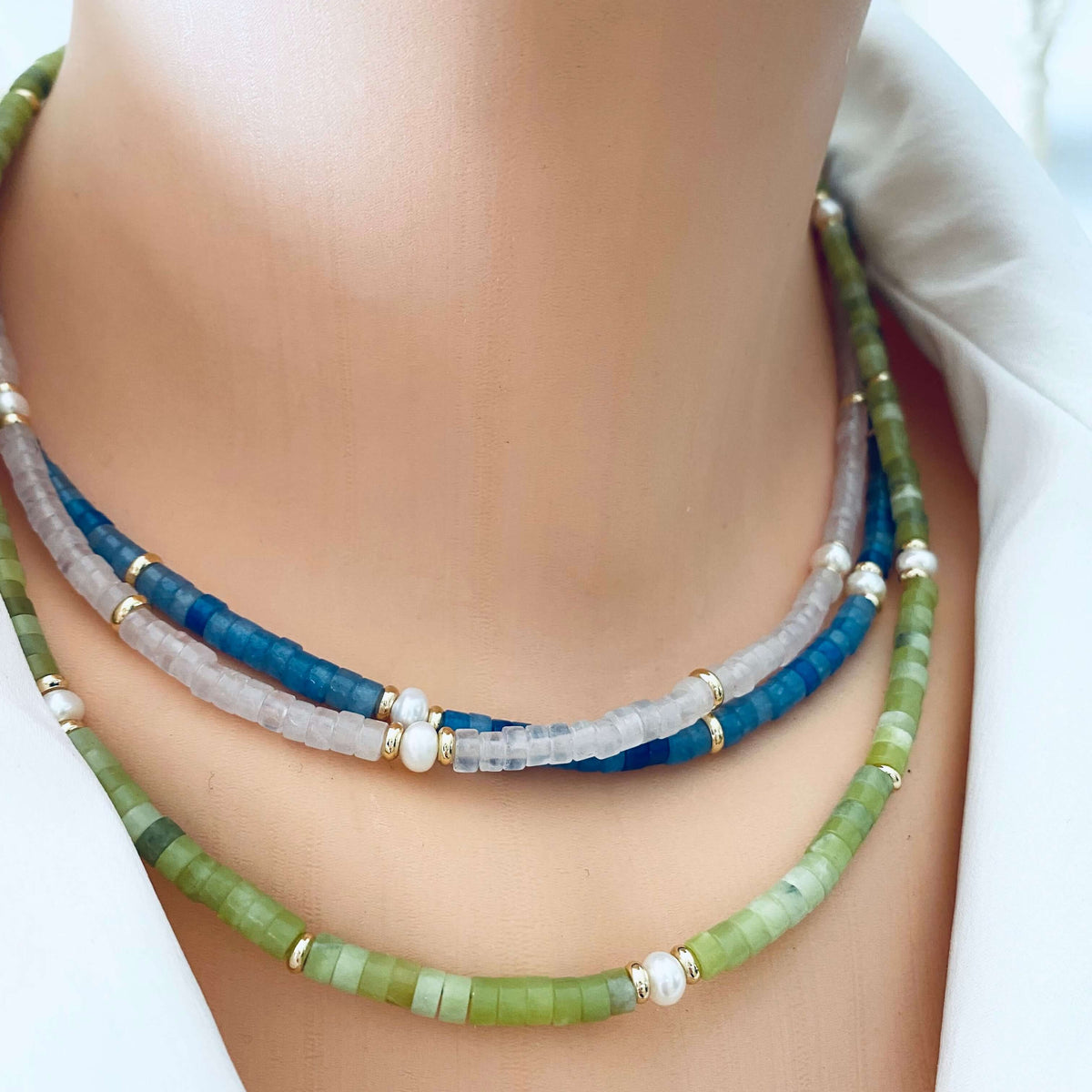 Multi gemstone choker necklaces layered with blue green and red gemstone strands