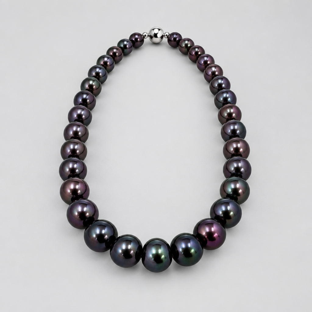 Black beaded necklace on a white fabric background