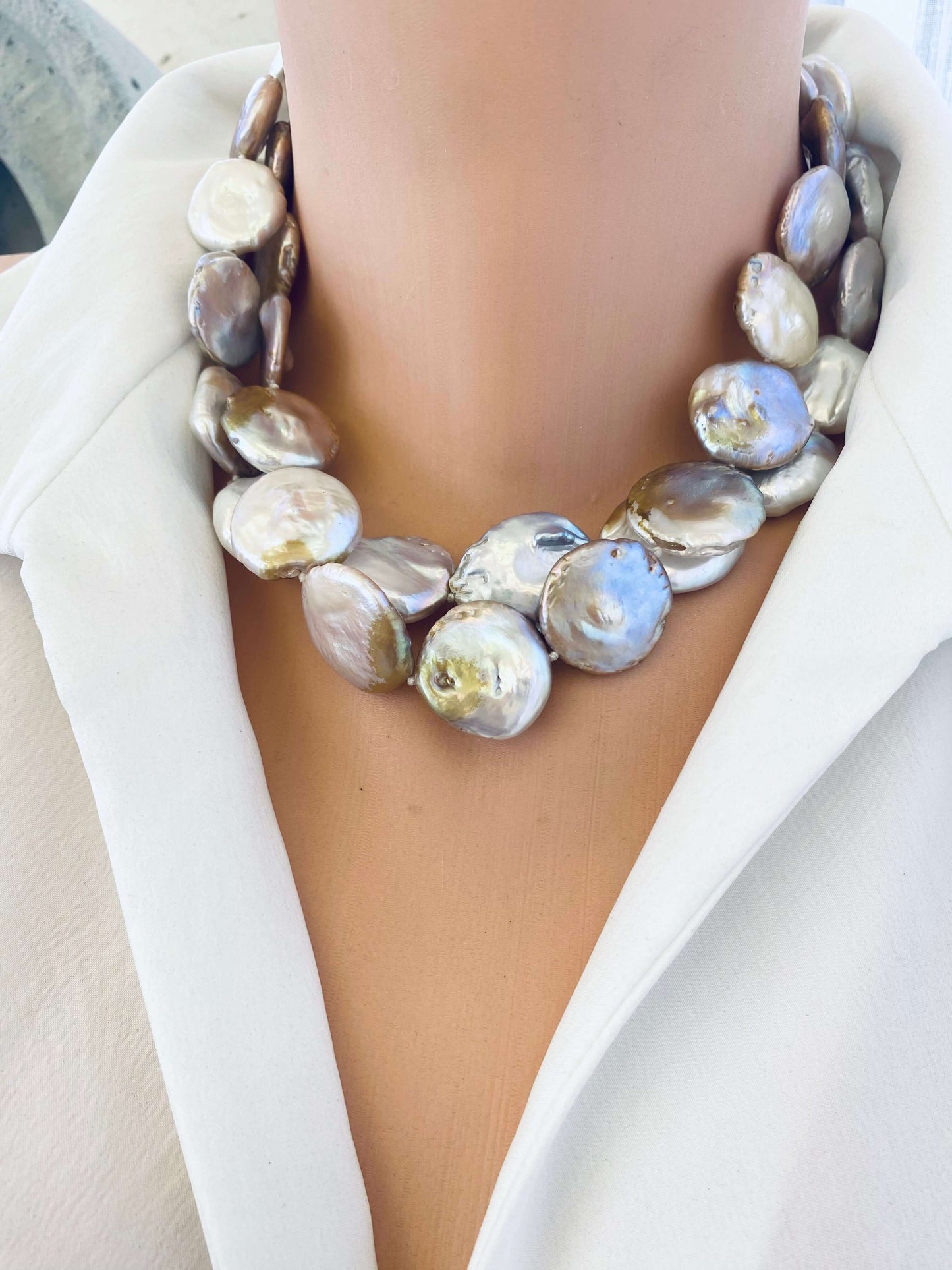 Large coin pearl necklace doubled on mannequin neck, layered statement look