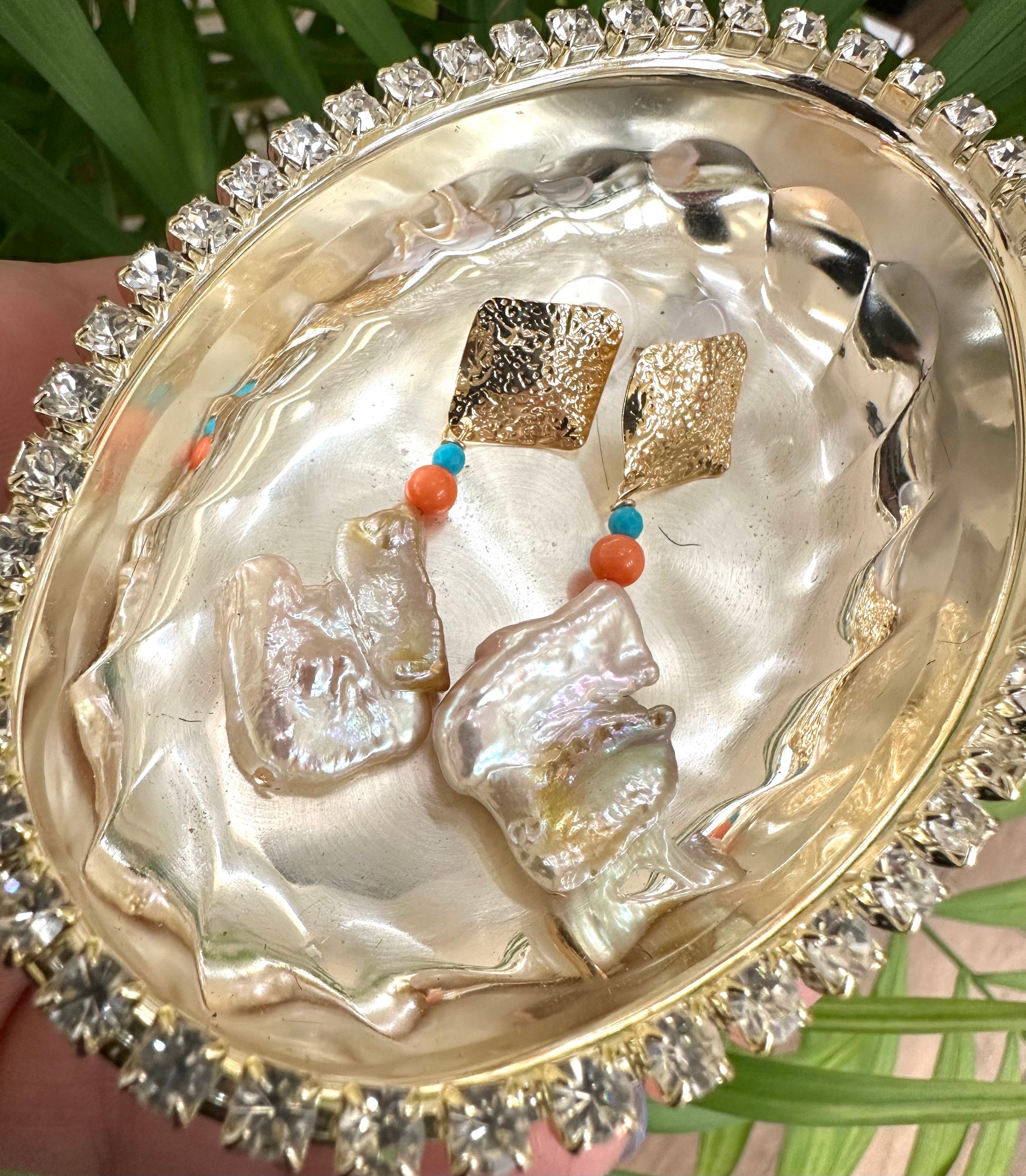 Baroque Pearl Turquoise Coral Earrings displayed in a shiny decorative bowl, showcasing their chunky gold design.