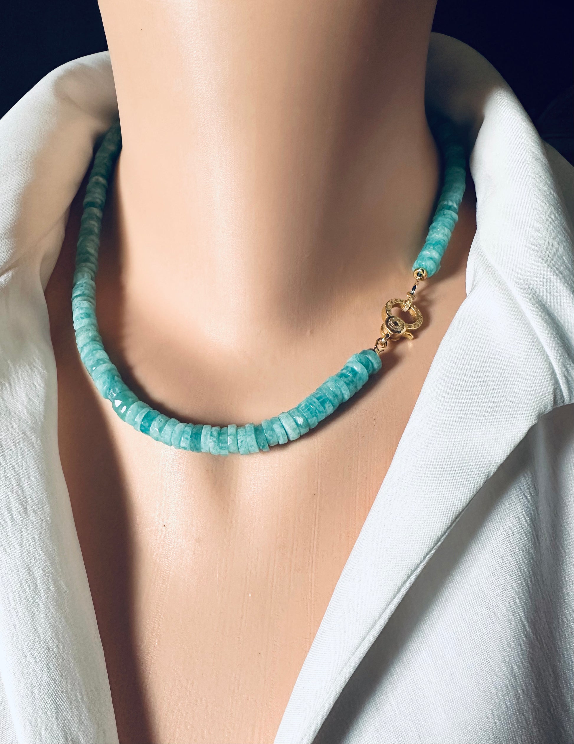 AMAZONITE beaded necklace with a gold clasp on a mannequin wearing a white outfit.