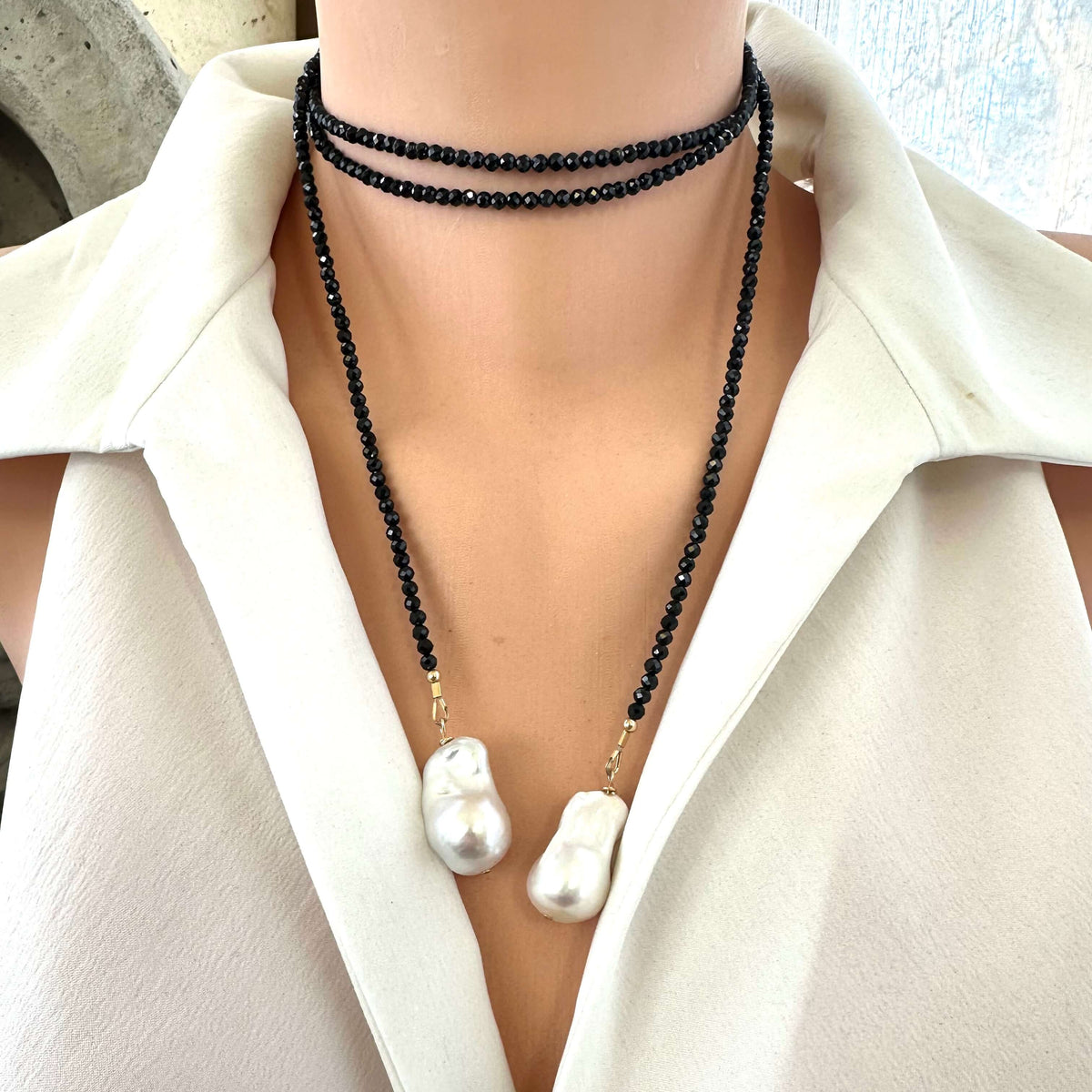 Black spinel lariat necklace featuring baroque pearls, showcasing modern elegance and handmade craftsmanship.