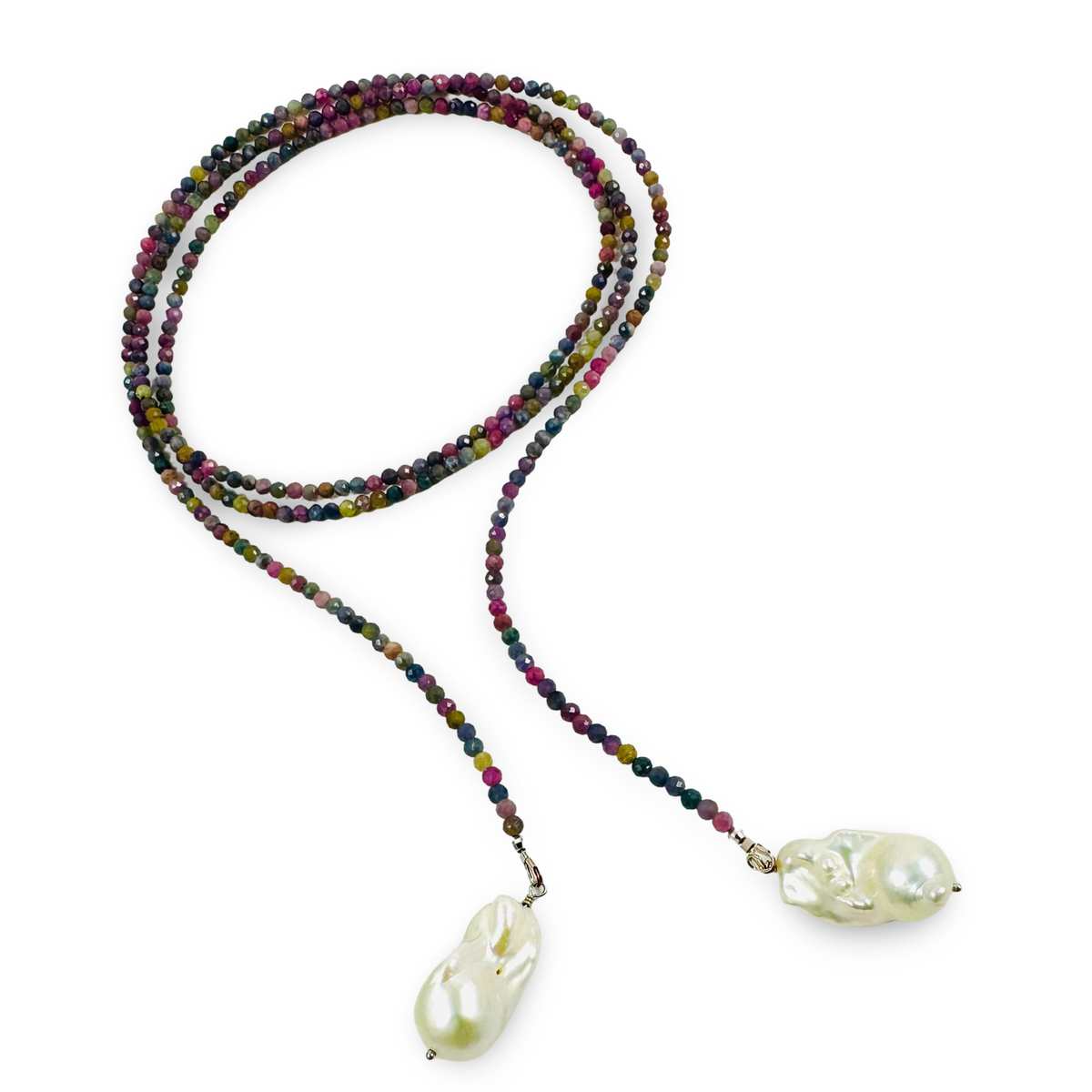 A long beaded necklace with a multicolor strand of faceted beads and two large, irregular white baroque pearls at the ends, displayed on a clean white background.