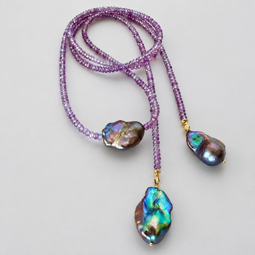 Close-up of Amethyst and Black Baroque Pearl Lariat Necklace on white background — faceted amethyst beads and baroque pearls handcrafted by Loulia Pearl Jewelry