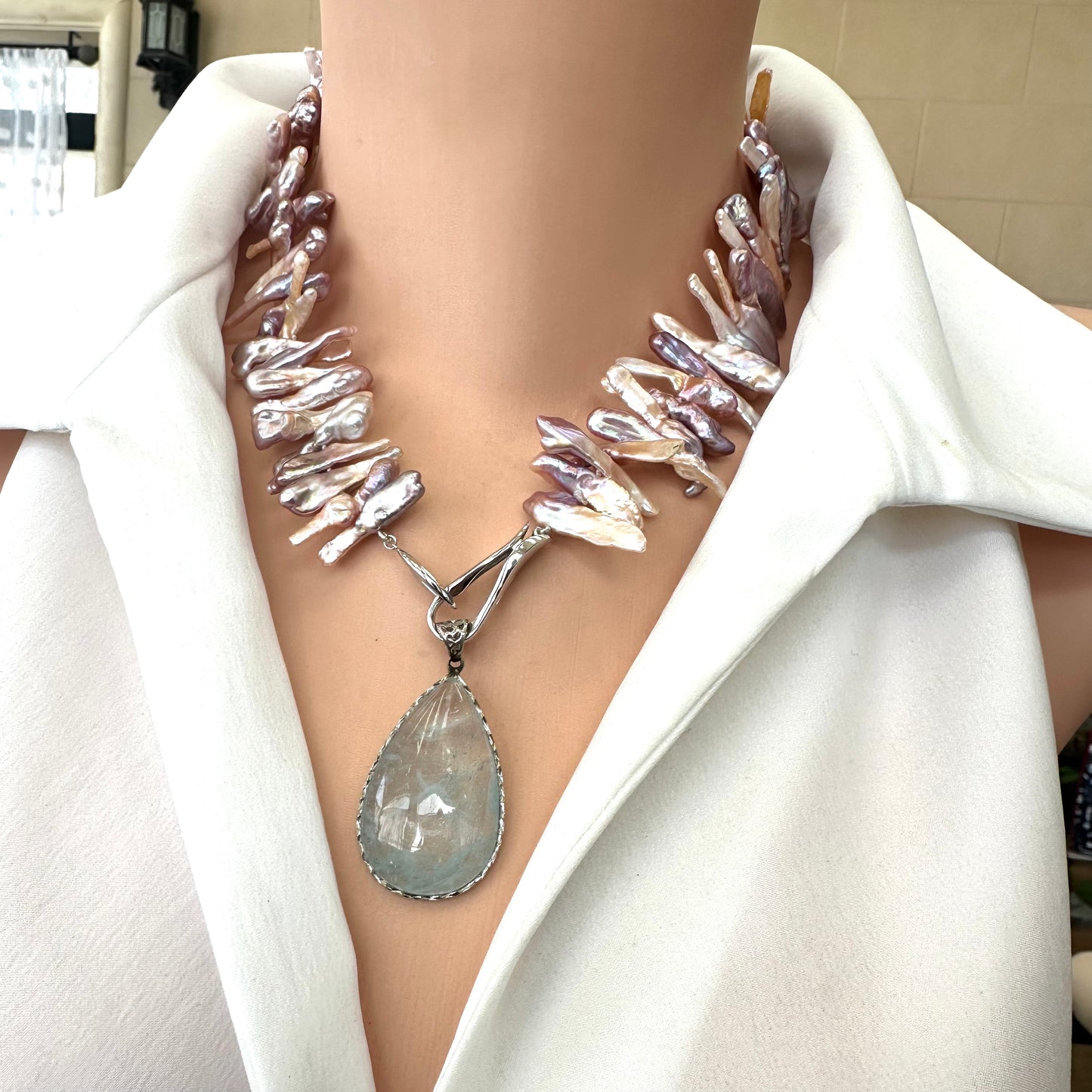 Biwa Pearl Necklace with added pendant attachment shown in side view on mannequin.