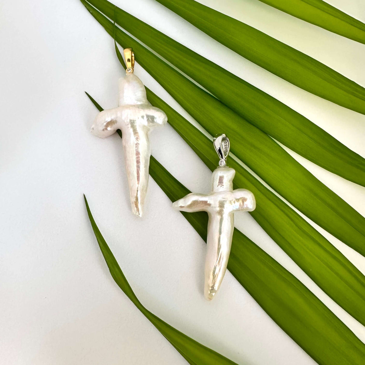 Baroque pearl cross pendant in rhodium-plated sterling silver, elegant handmade design.