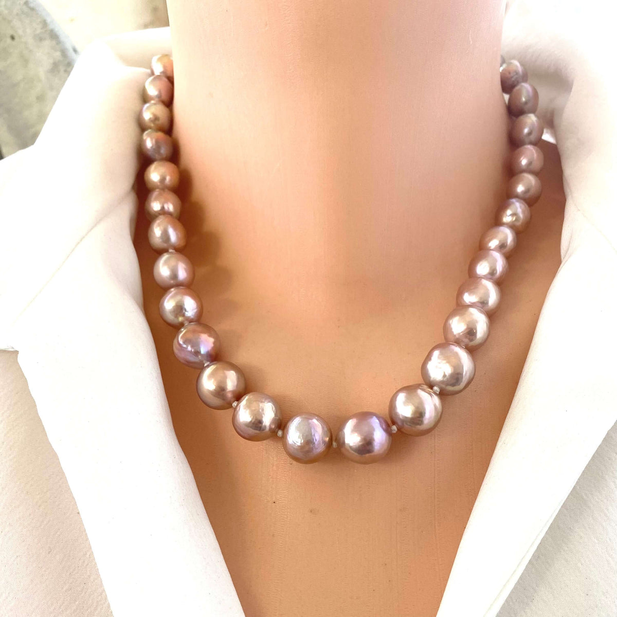 Baroque pink lavender pearl necklace worn on mannequin, capturing unique color variations and refined handmade design.