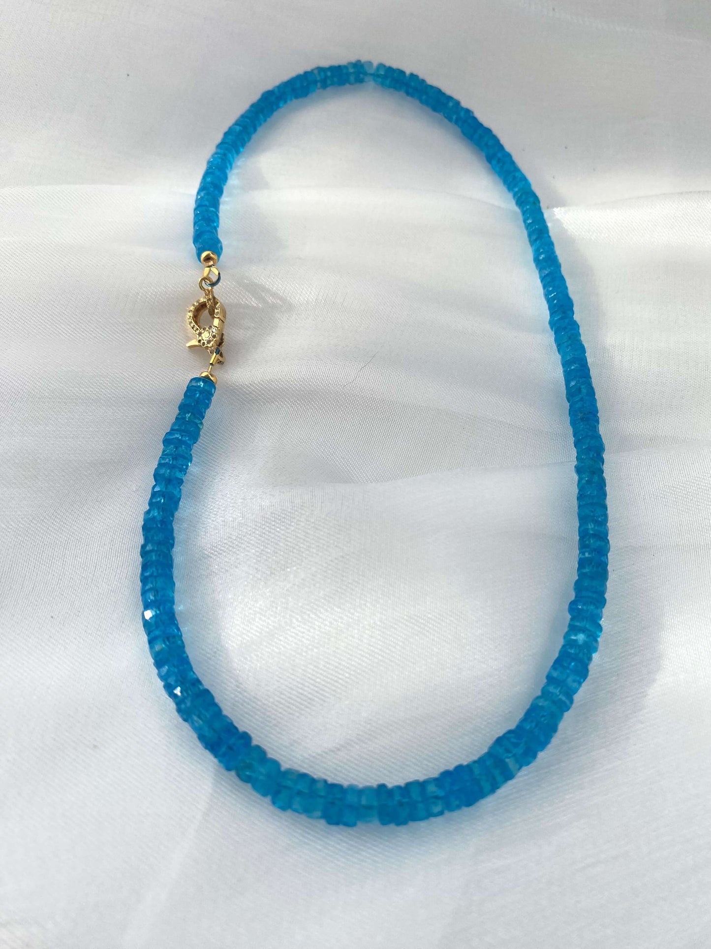 Blue topaz beaded necklace with gold vermeil pavé clasp, handcrafted with vibrant neon blue topaz heishi beads.