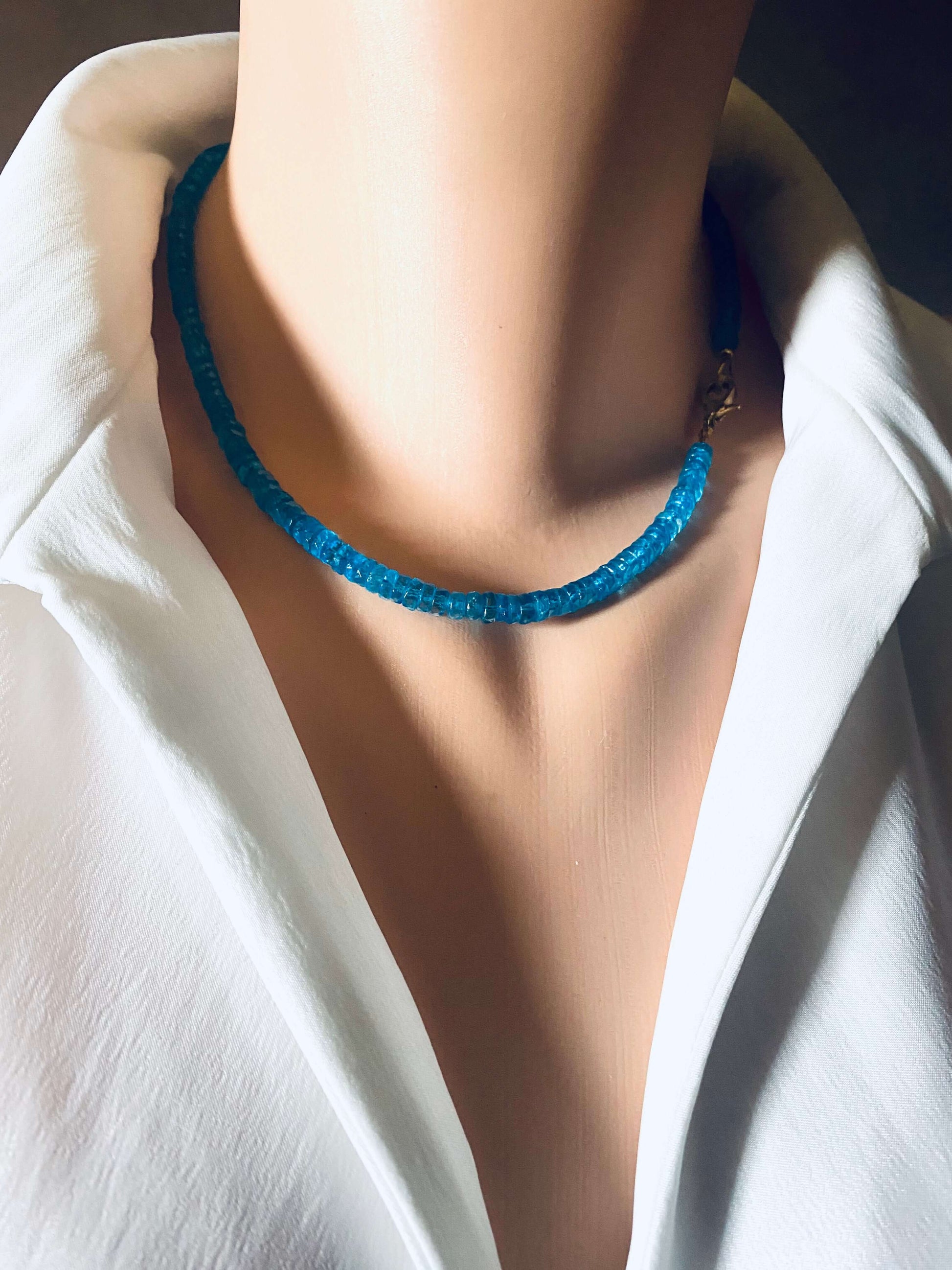 Blue topaz beaded necklace showcasing vibrant color and craftsmanship, worn on a mannequin with a white shirt.