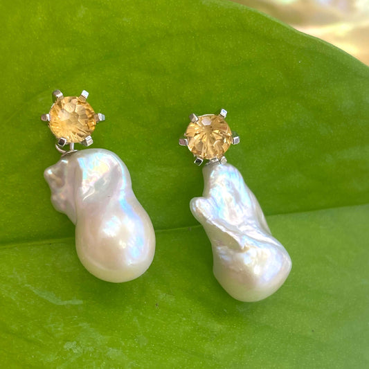 Citrine stud earrings with removable baroque pearl drops on green leaf backdrop