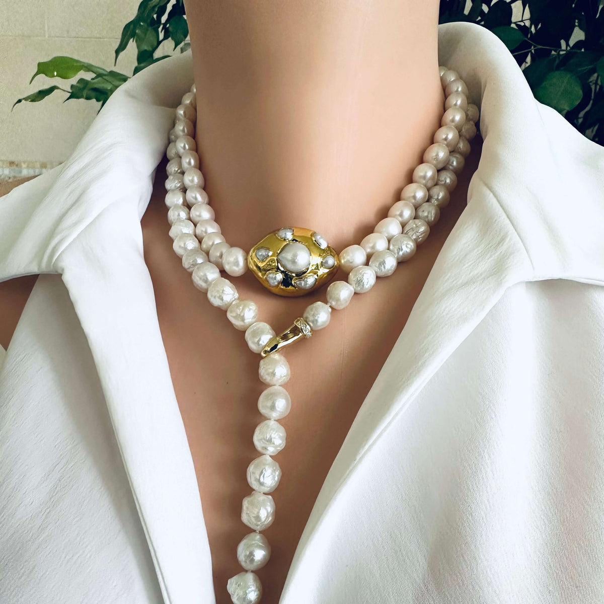 Edison pearl Y necklace featuring hand-knotted avocado baroque pearls worn by a model with a white blouse.