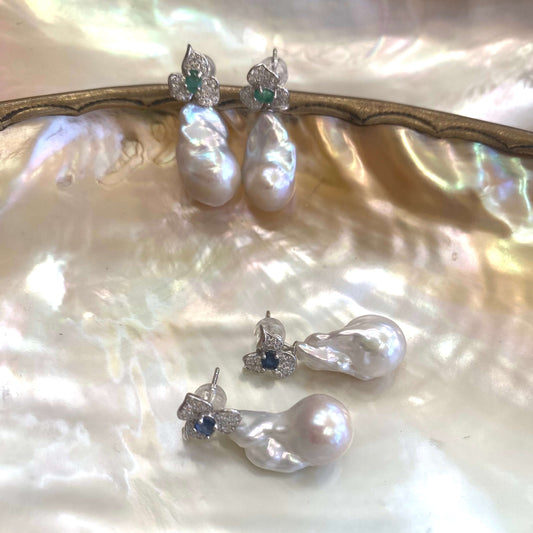 Emerald stud earrings and sapphire stud earrings with pearl drops on pearl shell