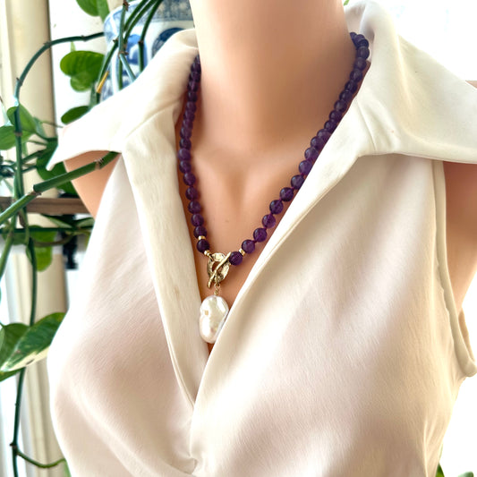 Amethyst toggle necklace with baroque pearl pendant worn at the neckline, handmade in Canada