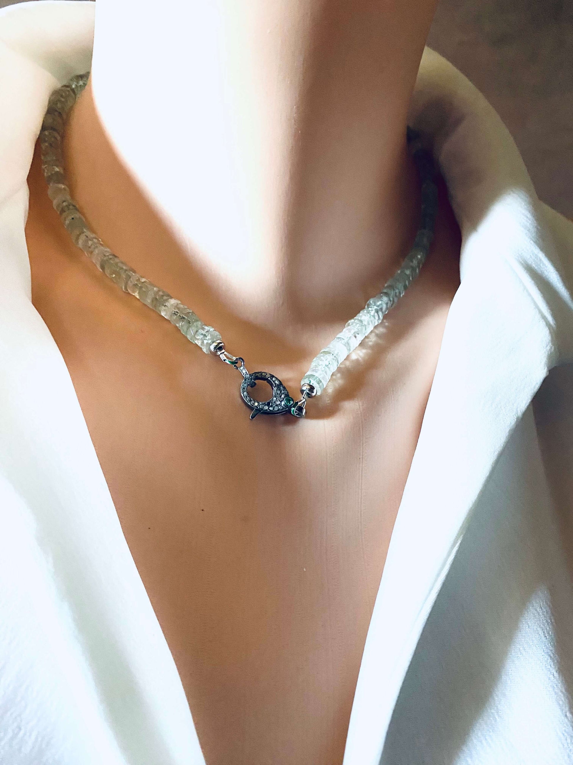 Green amethyst beaded necklace with diamond and emerald pavé clasp worn on a mannequin.