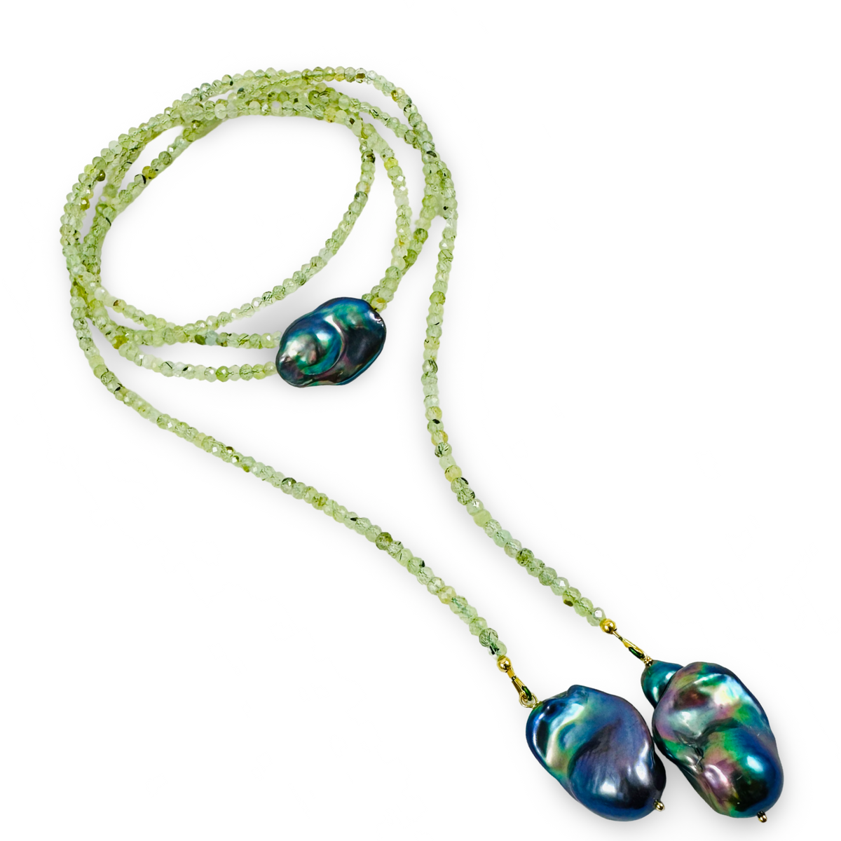 A beaded necklace featuring a long strand  of light green faceted beads with two large, irregular baroque pearls in iridescent blue, green, and purple tones, displayed on a clean white background.