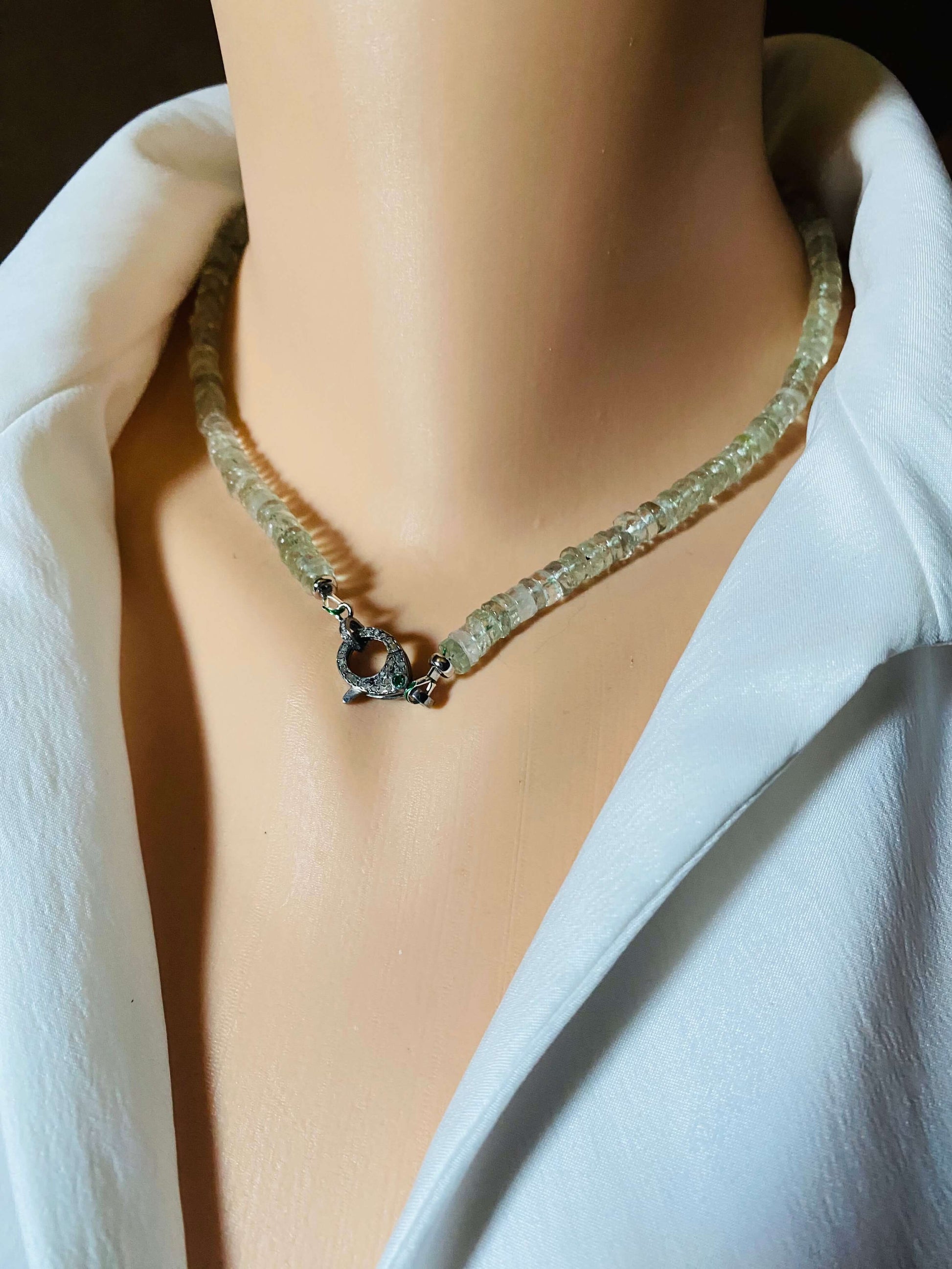 Green amethyst beaded necklace with diamond and emerald pavé clasp on a mannequin.