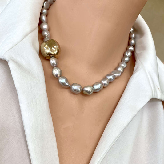 Grey pearl necklace with gold marine clasp worn on model sitting at the collarbone
