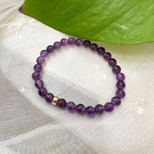 Amethyst Bracelet displayed on white cloth – gemstone bead close-up