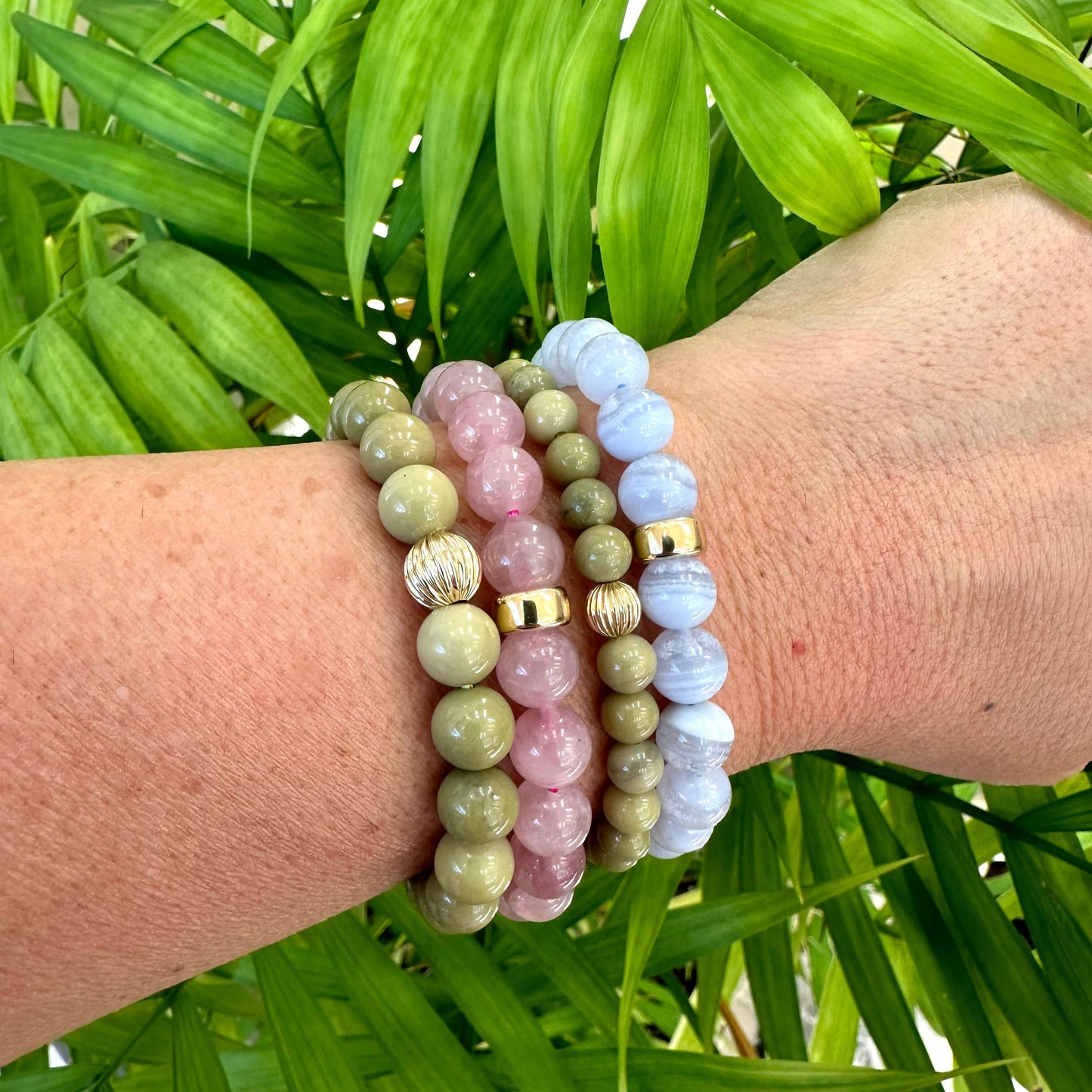 Blue Lace Agate Bracelet worn with mixed bracelets on woman’s wrist – layered style