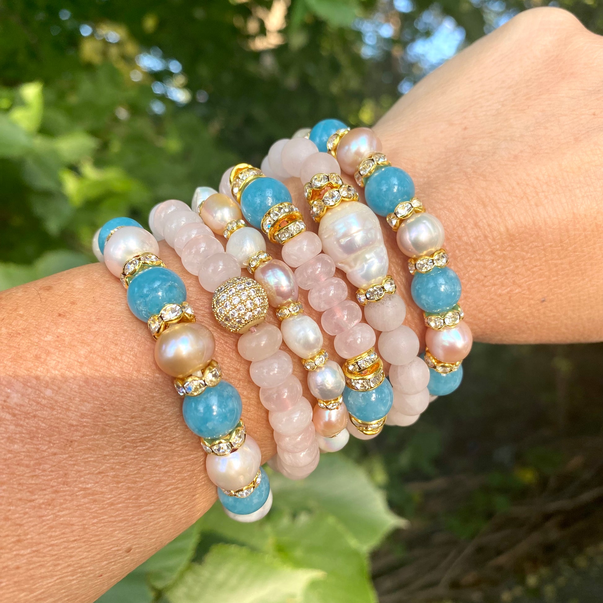 Blue sponge rose quartz pearl stretchy bracelet stacked on wrist showing pastel gemstone combinations