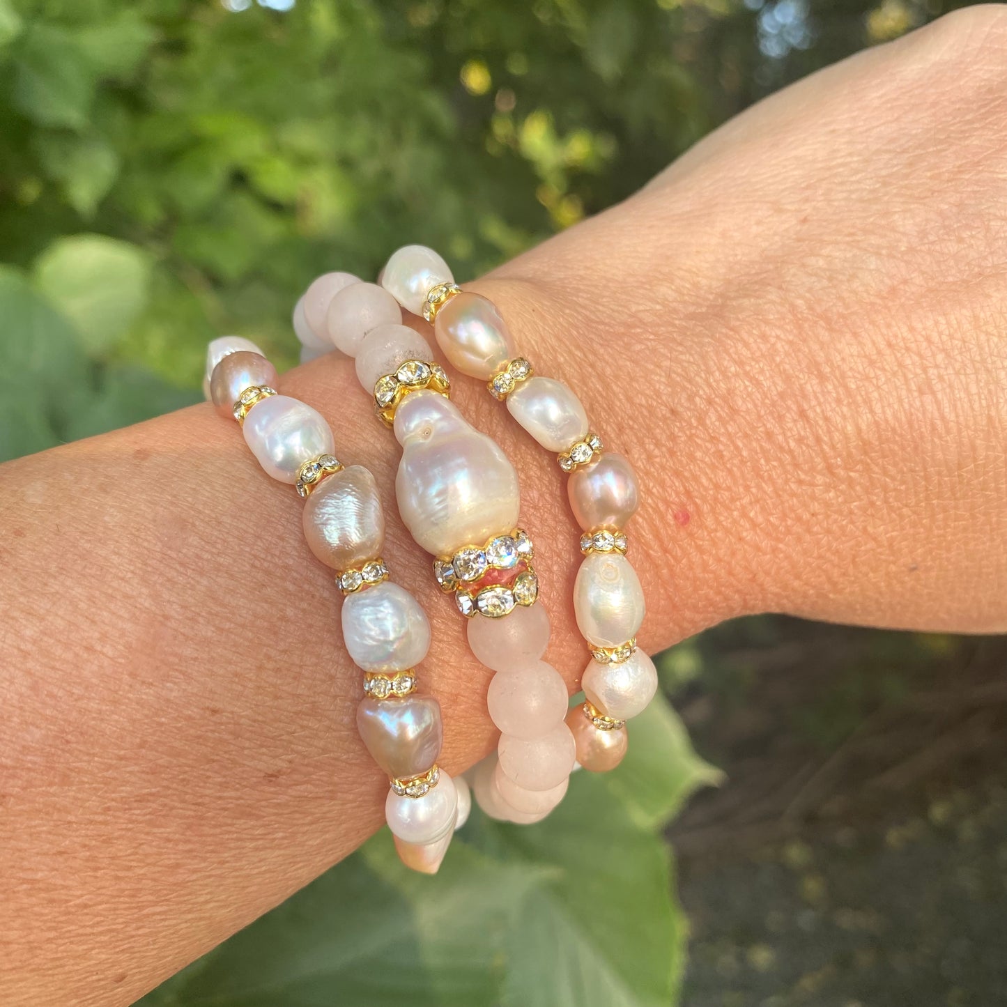 Blue sponge rose quartz pearl stretchy bracelet styled stacked on wrist with soft pastel tones