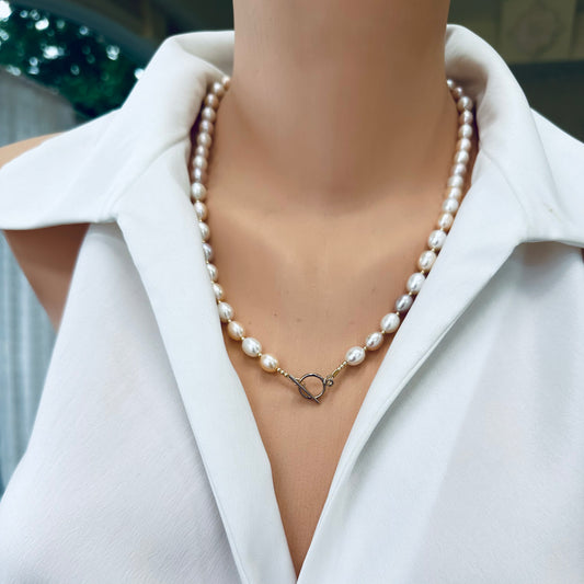 Pastel pearl necklace worn on mannequin, frontal view