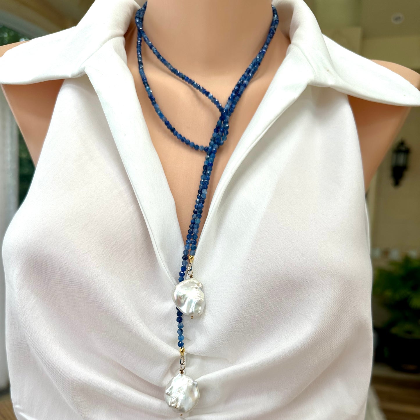 Kyanite and baroque pearl lariat necklace displayed on a mannequin, showcasing its elegant design and craftsmanship.