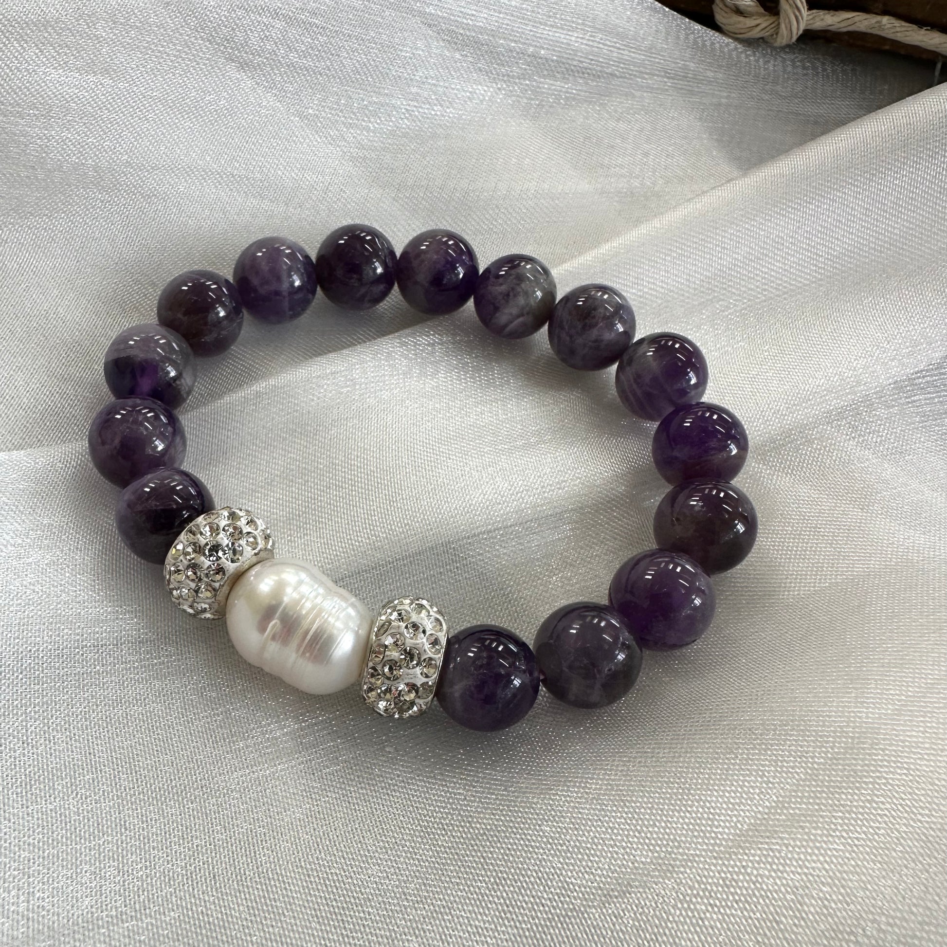 Chevron amethyst bracelet displayed on white cloth background