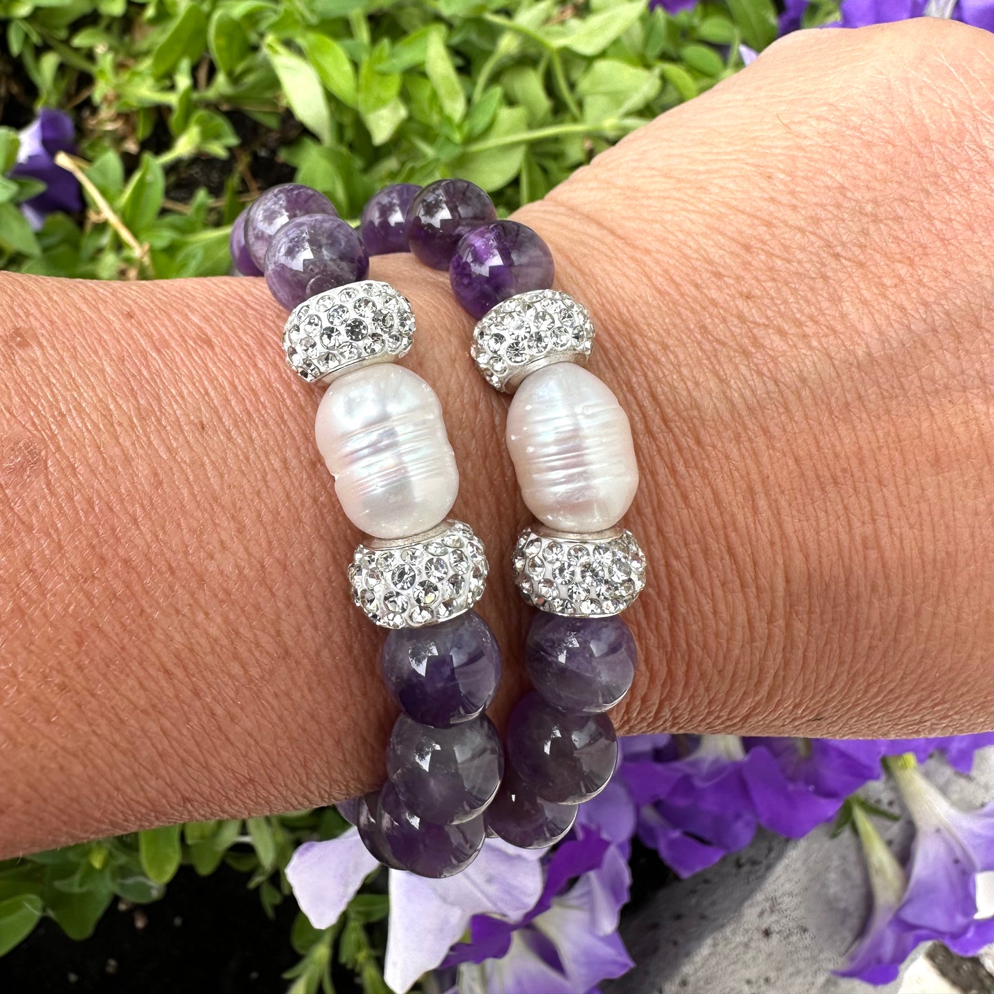Chevron amethyst bracelet worn on female wrist with stacked bracelets