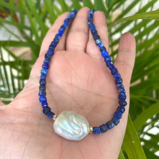 Delicate lapis lazuli baroque pearl necklace showing small faceted beads and white pearl