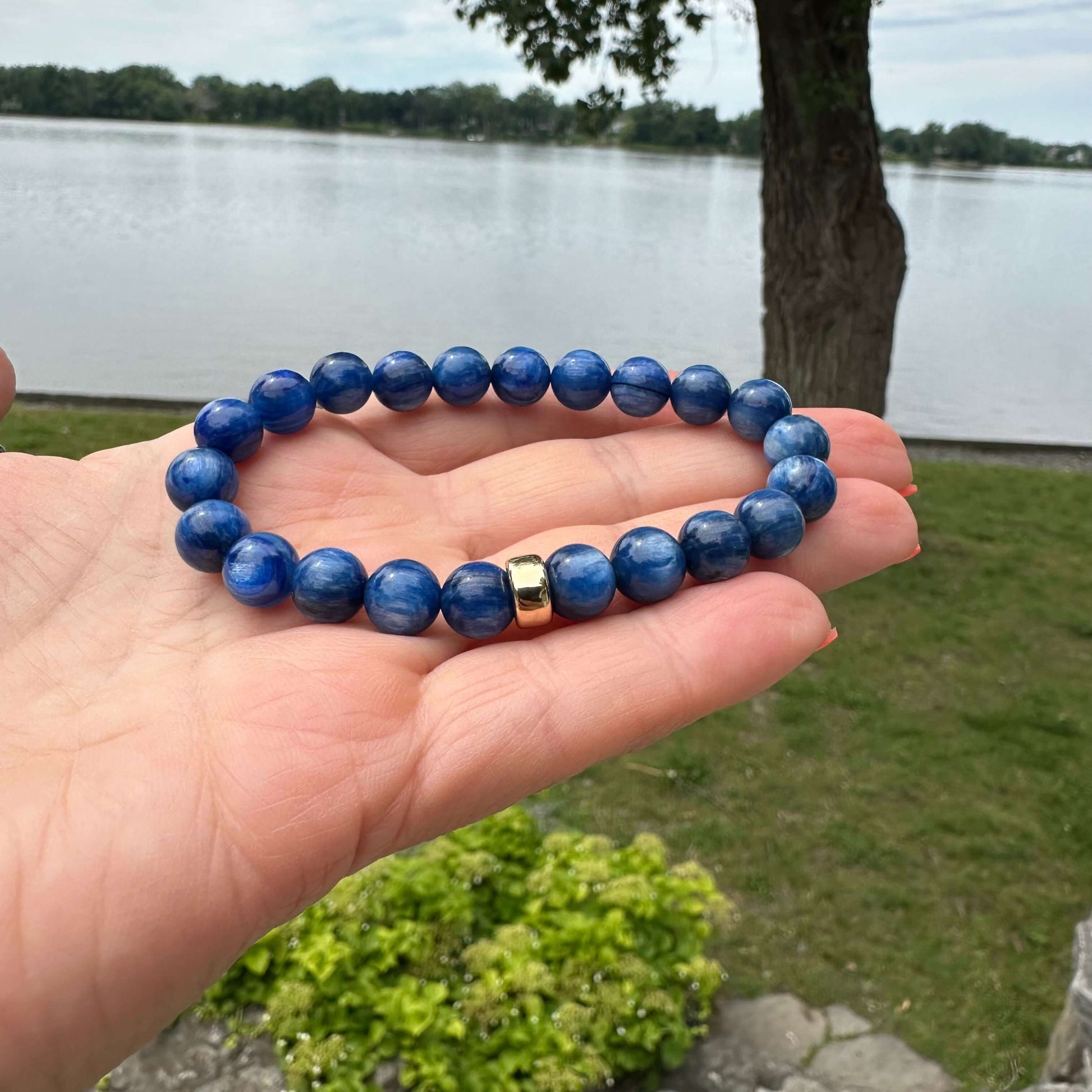 Blue kyanite bracelet shown in hand in natural light