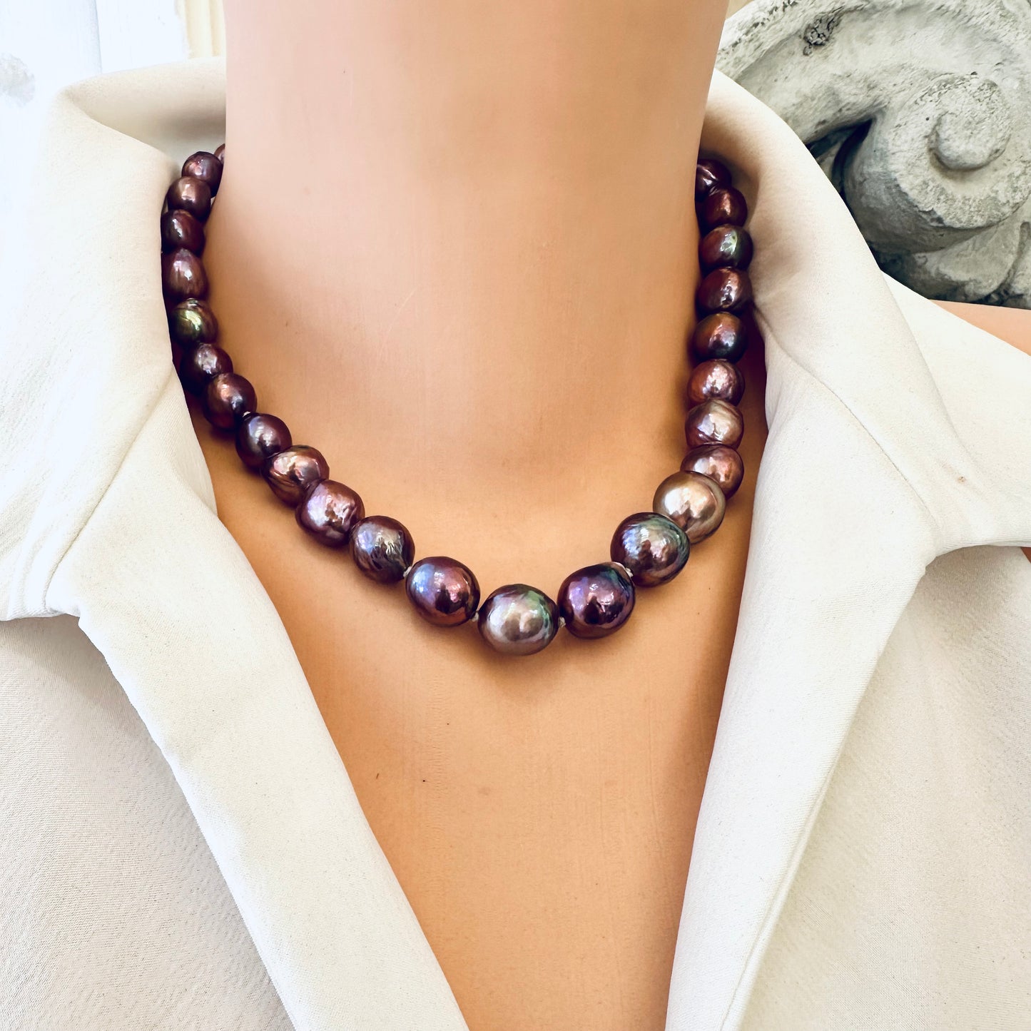 Purple Edison baroque pearl necklace draped on mannequin showing luster