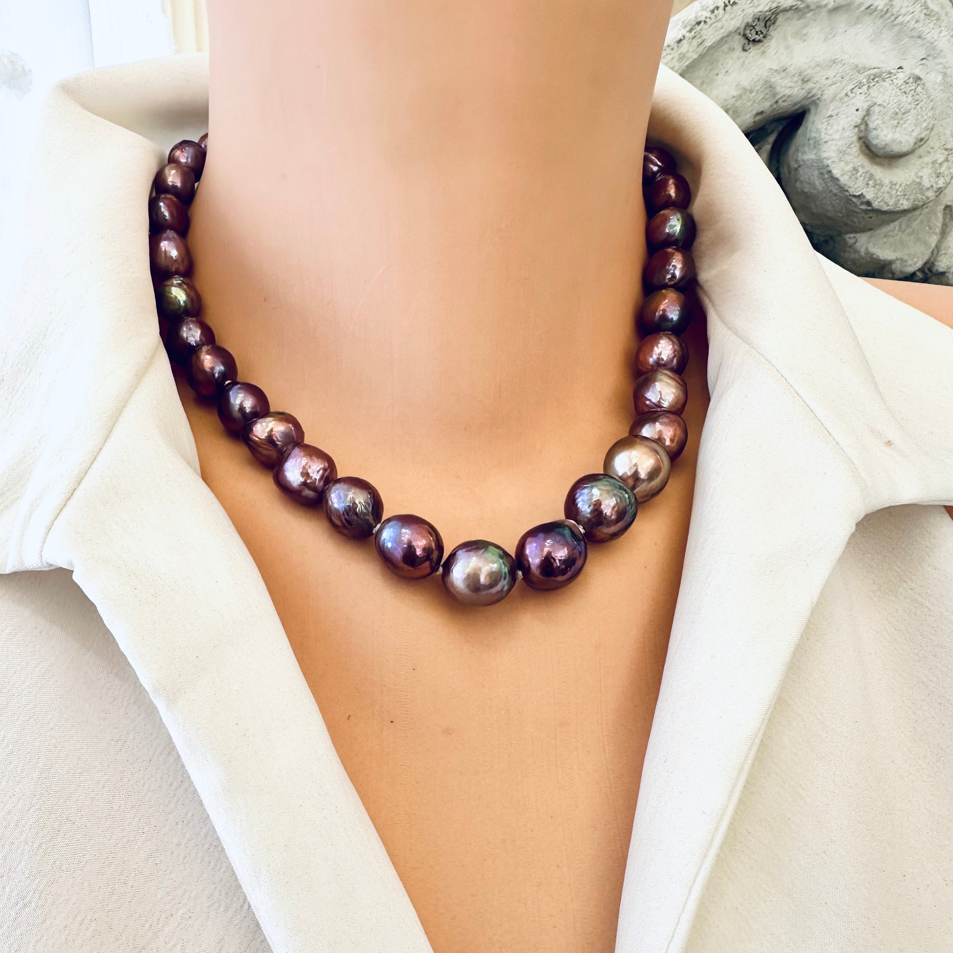 Purple Edison baroque pearl necklace draped on mannequin showing luster