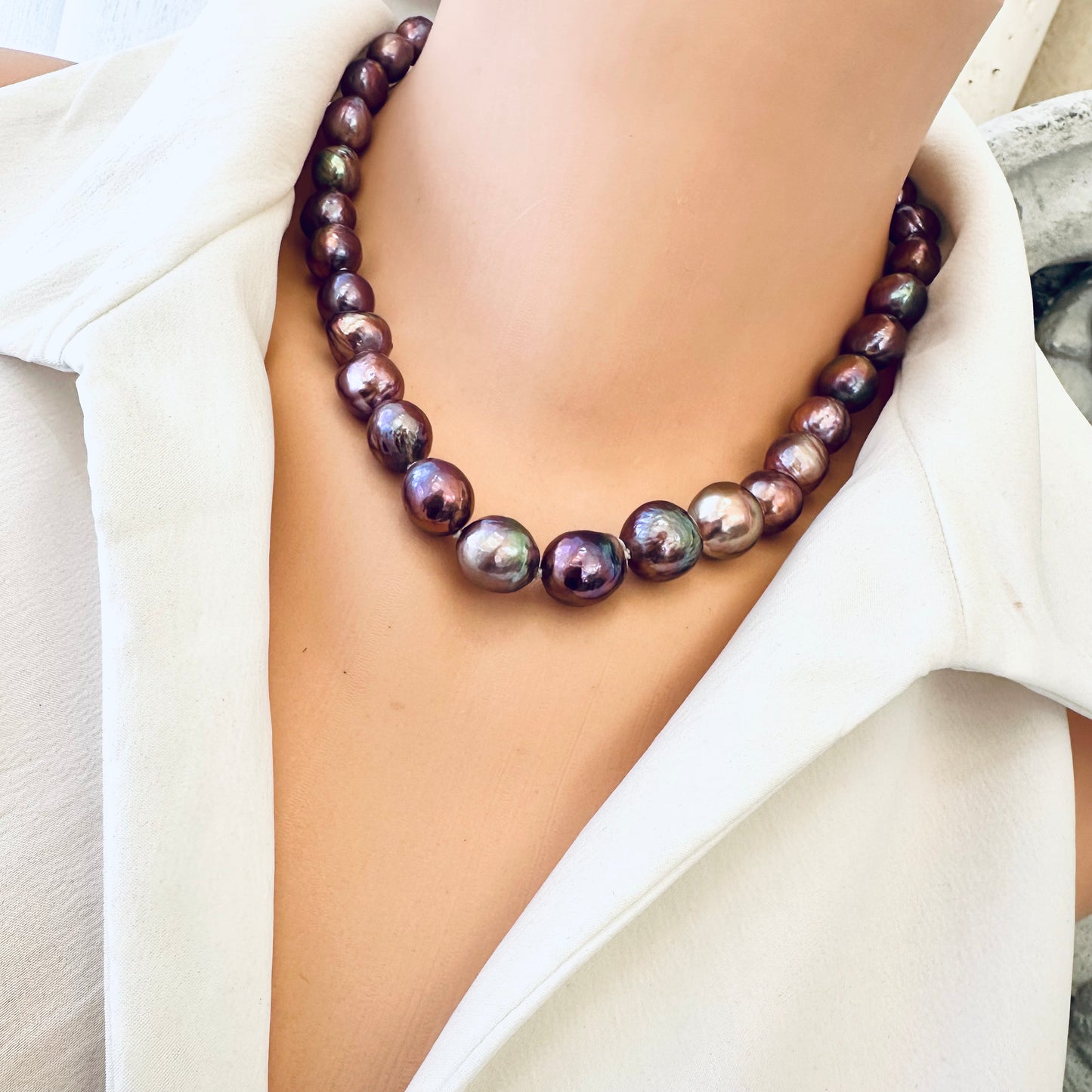 Side close-up of purple Edison baroque pearl necklace worn on mannequin
