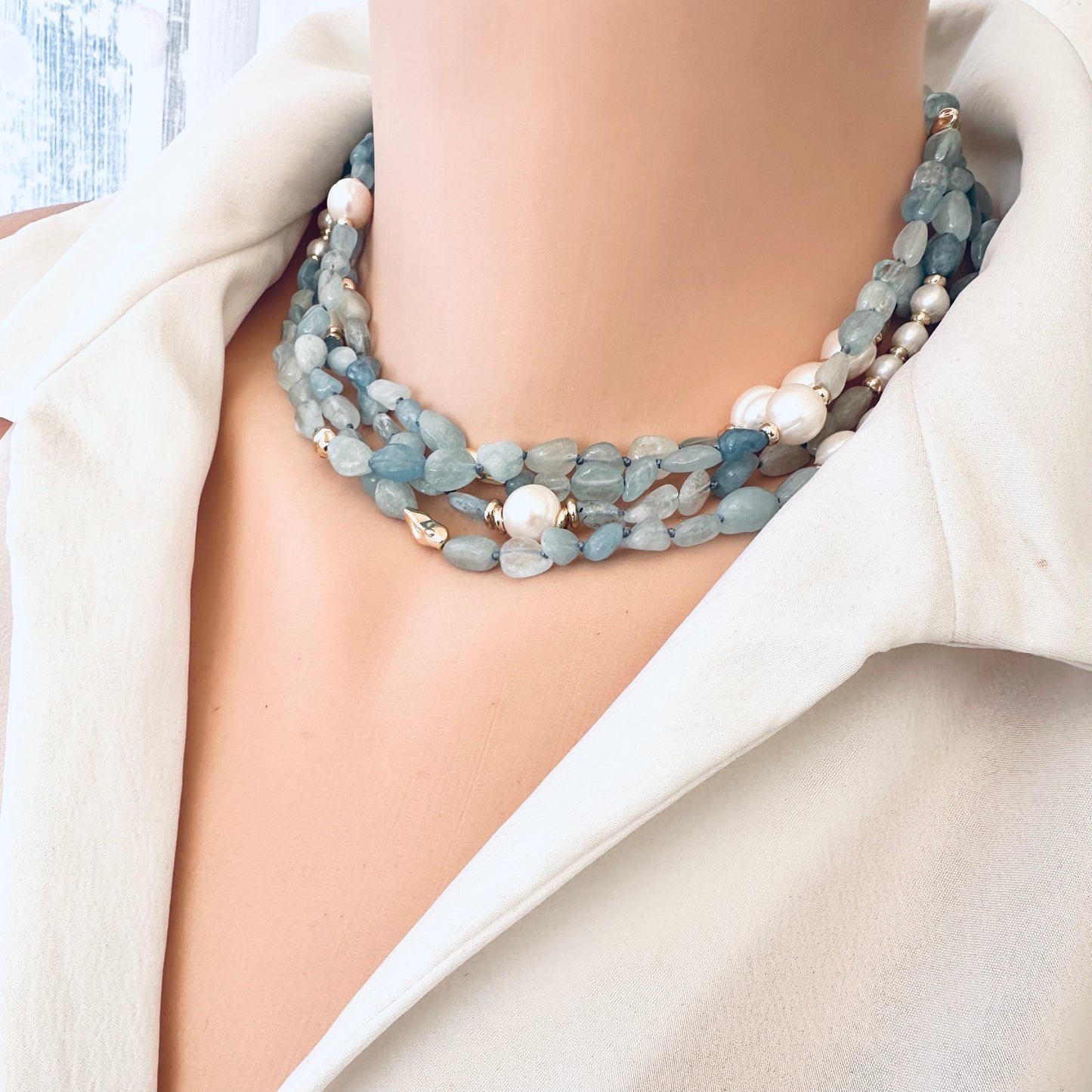 Aquamarine and pearl necklace worn as a choker on mannequin