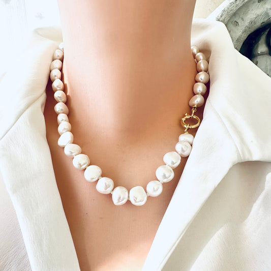 Small baroque pearl classic necklace worn on model, showcasing the elegant pearls and golden clasp.
