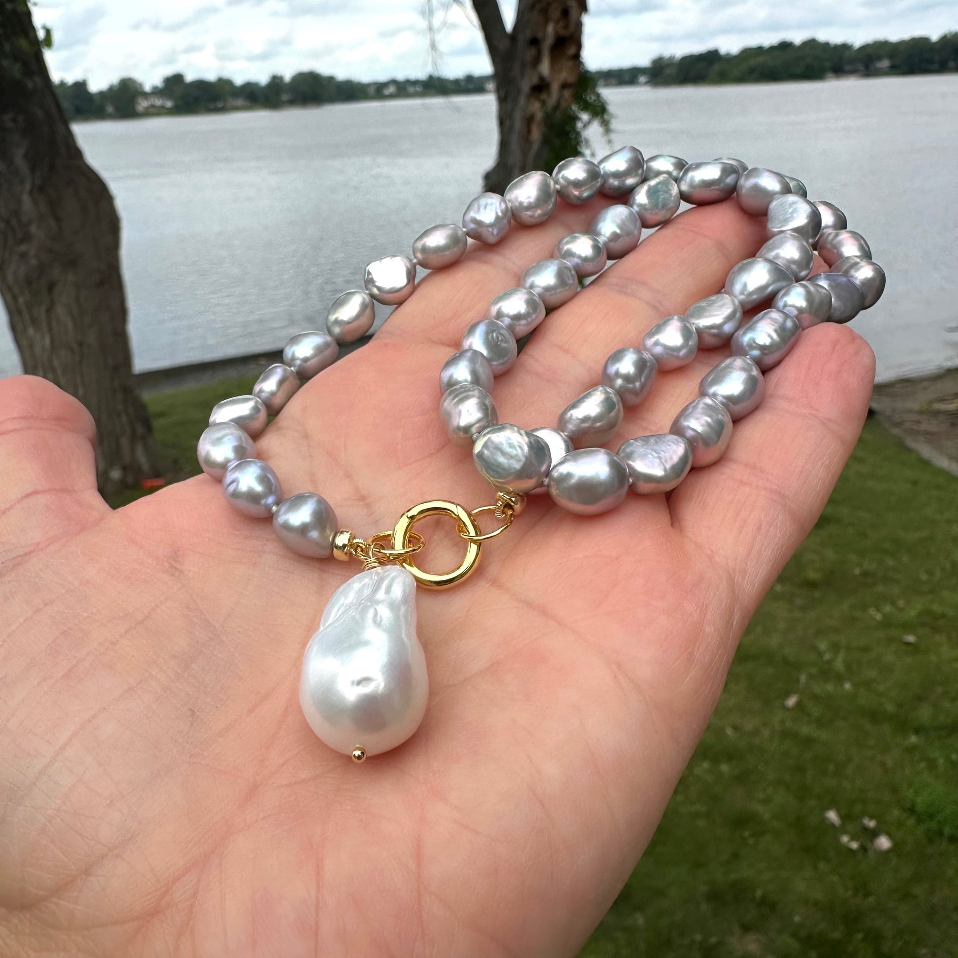 Grey pearl necklace featuring white baroque pearl pendant, handcrafted with silver-grey freshwater pearls.