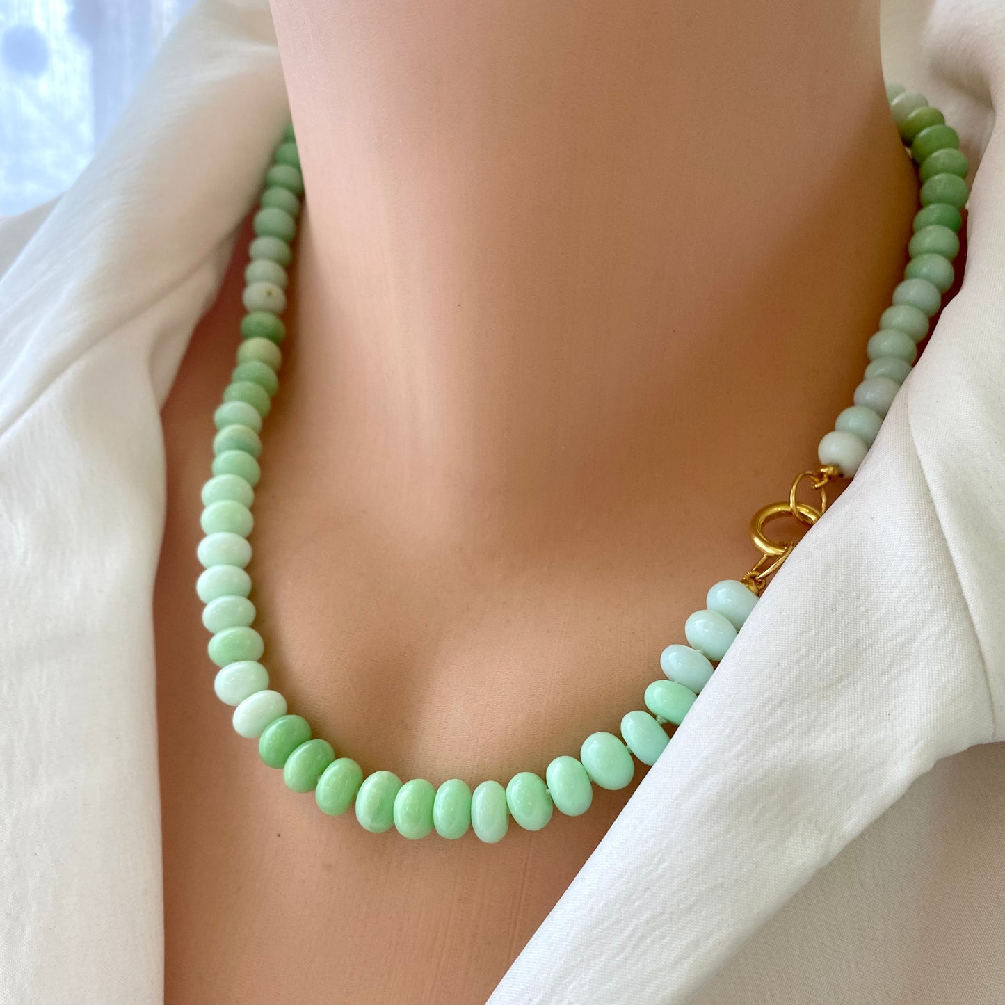 Green opal beaded necklace worn on mannequin, close-up view