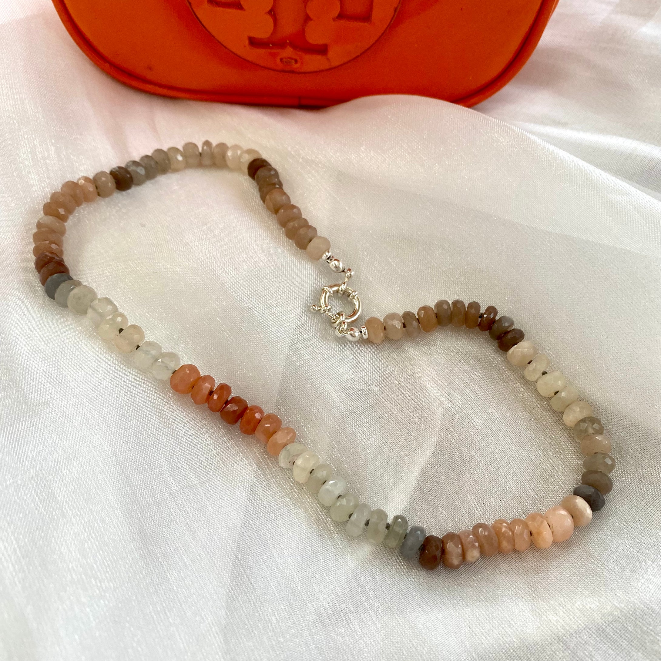 Hand-knotted candy choker necklace featuring 6mm faceted moonstone, labradorite, and sunstone beads, with a sterling silver marine clasp. The necklace measures 16 inches and offers a colorful and elegant design.