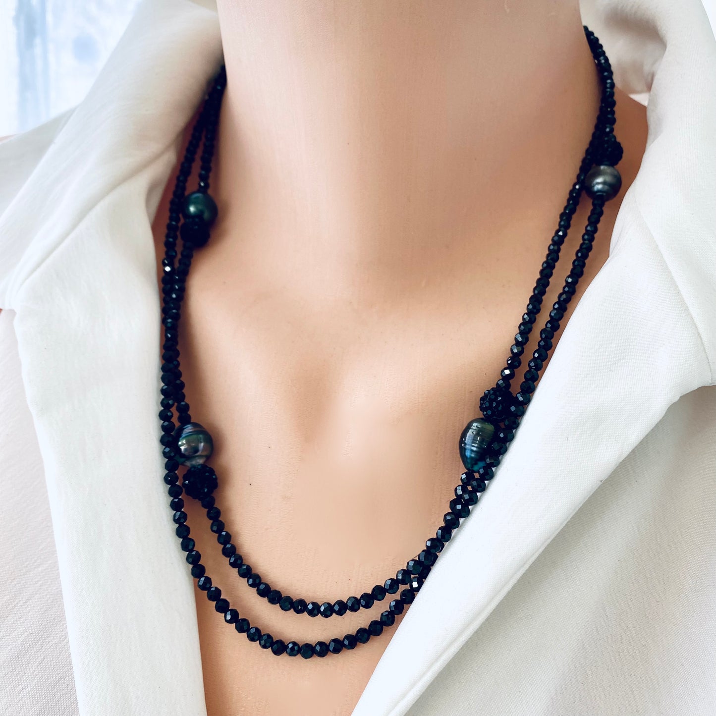 Black spinel pearl necklace worn on mannequin, layered styling detail