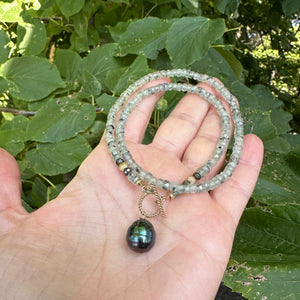 This necklace features a delicate chain of soft, translucent faceted green Prehnite rondelle beads, beautifully complemented by a striking Tahitian baroque pearl as the centerpiece pending from a cold filled toggle clasp. 18"inches long