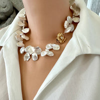 Romantic & elegant White Keshi Pearl Necklace. Featuring lustrous petal-shaped Keshi pearls, finished with a large gold-plated one of a kind flower box clasp that adds a charming, vintage-inspired detail. 17.5 inches long.