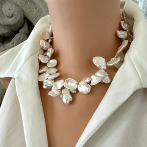 Romantic & elegant White Keshi Pearl Necklace. Featuring lustrous petal-shaped Keshi pearls, finished with a large gold-plated one of a kind flower box clasp that adds a charming, vintage-inspired detail. 17.5 inches long.