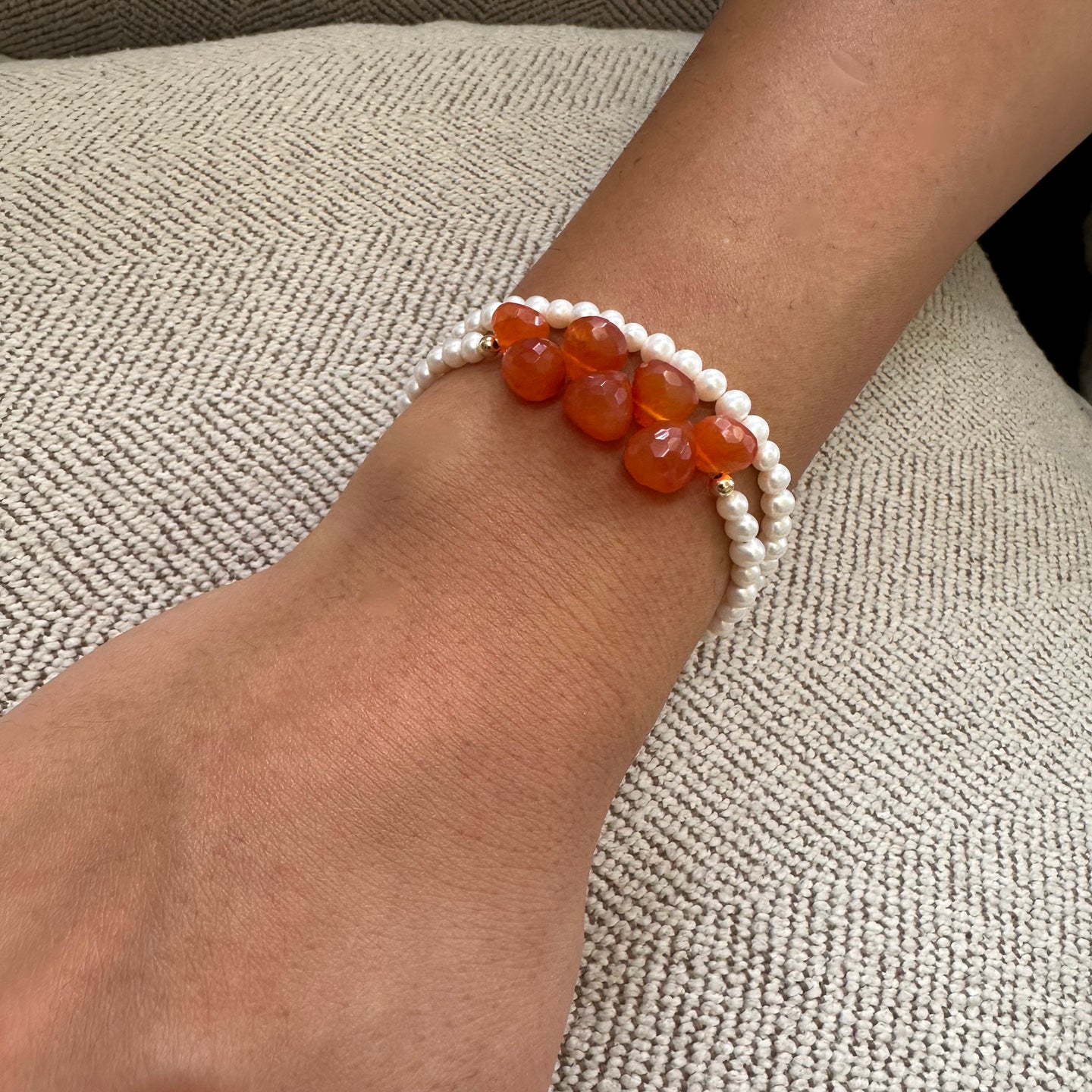 double wrap bracelet, featuring one long strand of lustrous freshwater pearls 4mm accented by stunning deep orange Carnelian Onion briolettes. Gold filled lobster clasp