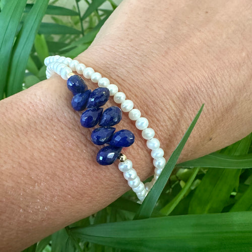 double wrap bracelet, featuring two strands of shimmering freshwater pearls beautifully accented with deep blue Lapis Lazuli teardrop briolettes, Gold filled details.