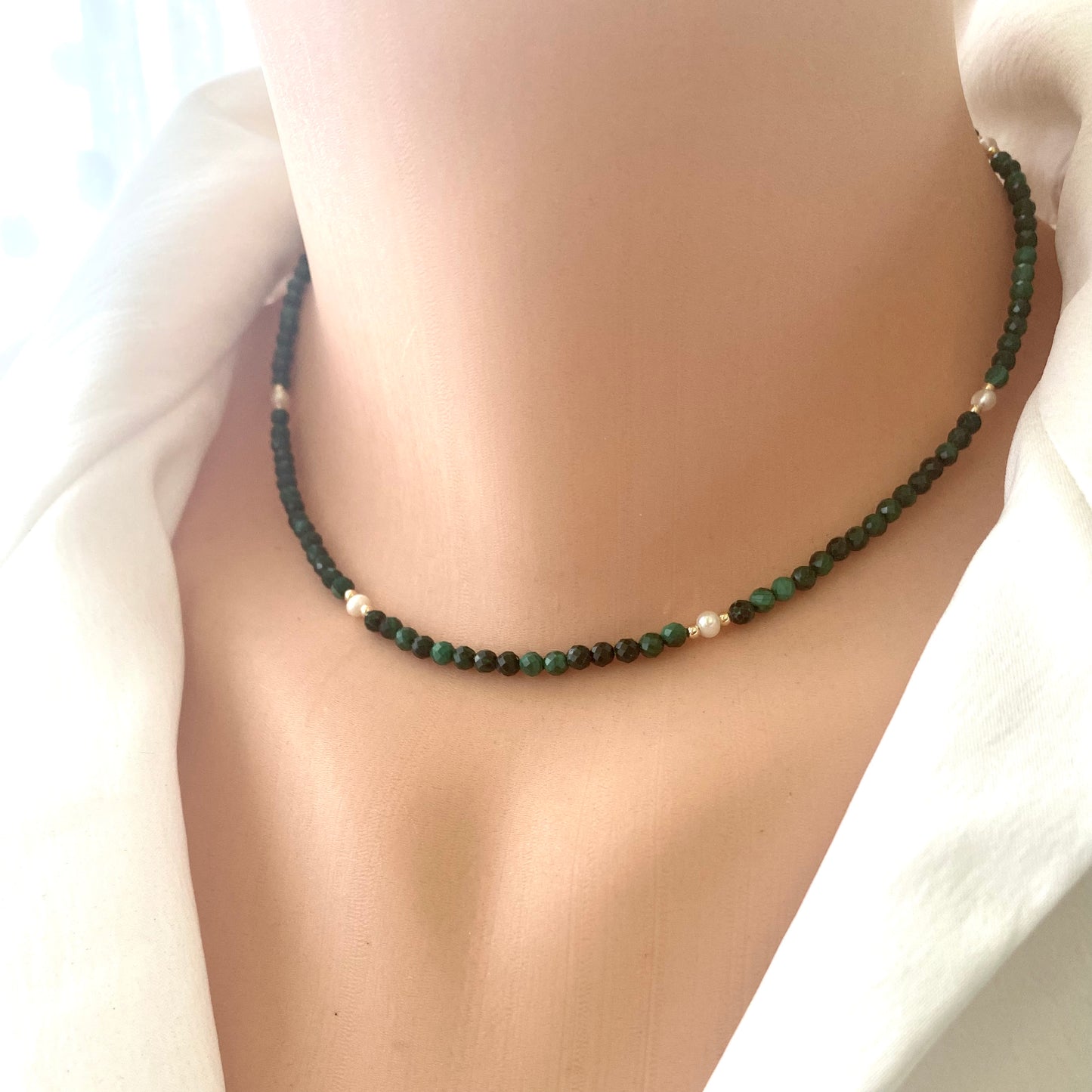 Malachite Pearl Choker Necklace featuring rich malachite beads and luminous freshwater pearls, worn elegantly on a model.