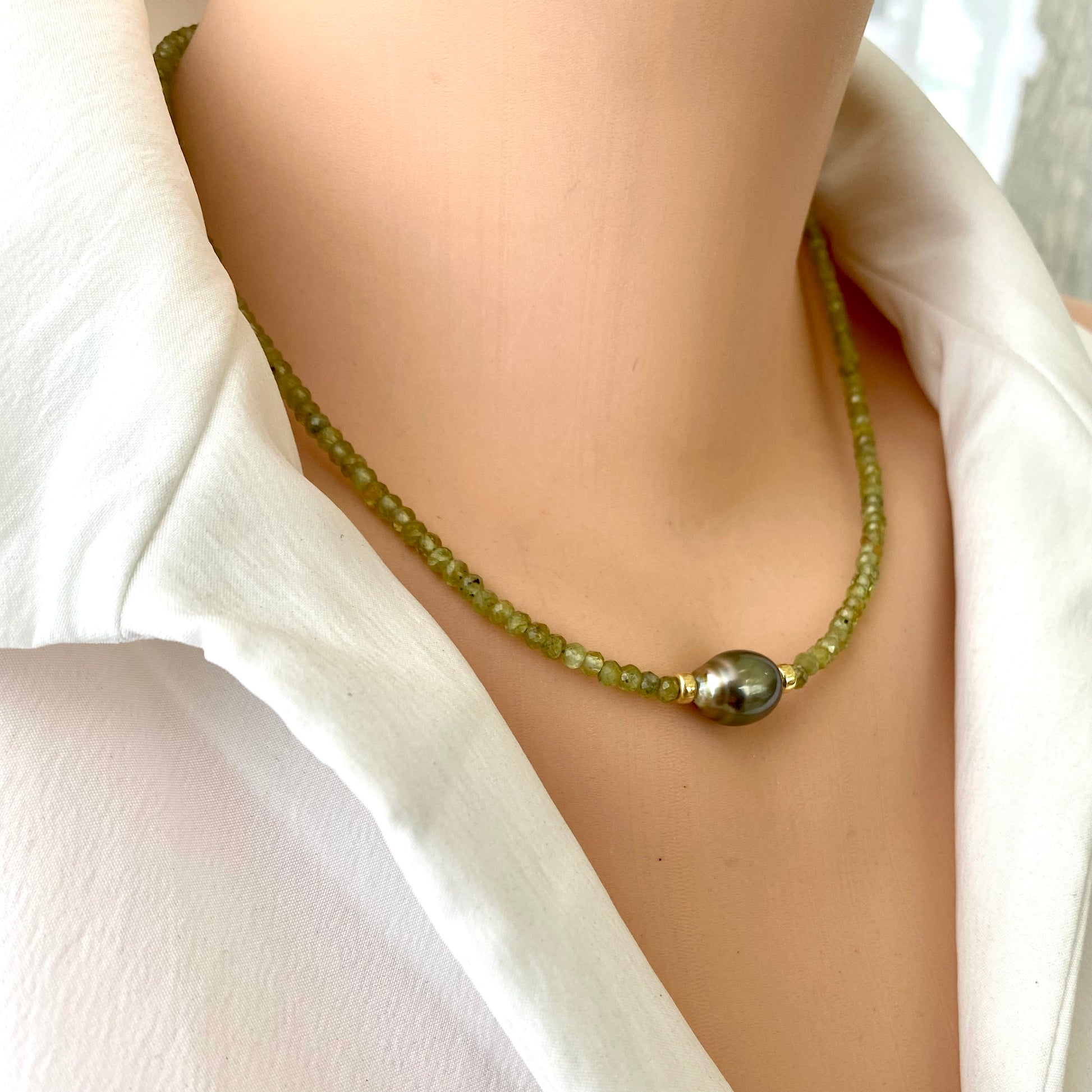 Peridot baroque pearl necklace showcasing vibrant green Peridot beads and a striking Tahitian pearl.