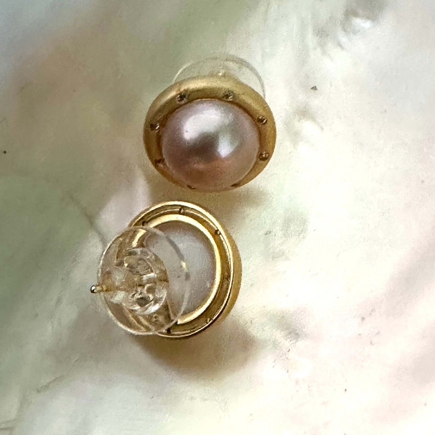 Back and front view of pink mabe pearl stud earrings on white shell, highlighting gold vermeil posts and handcrafted finish.